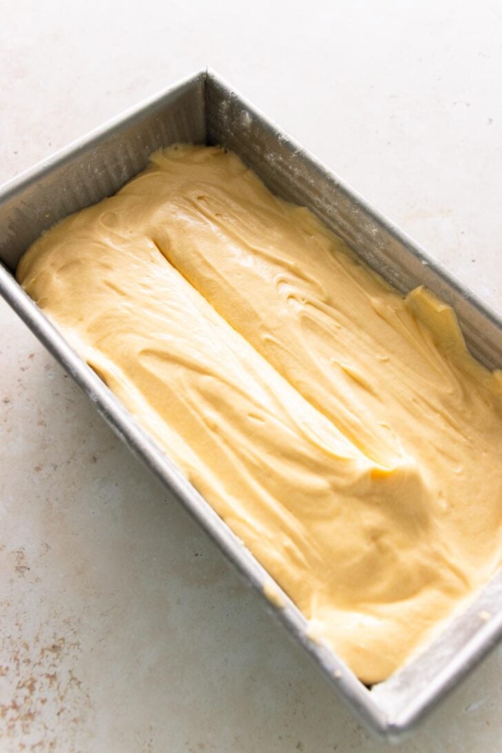 A line is scored into the surface of the pound cake batter.